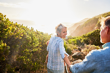 Image showing Love, holding hands and nature, senior couple walking with picnic blanket for romance and valentines day. Green mountain path, old man and woman on walk or hike for romantic valentine date at sunset.
