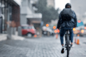 Image showing Cyclist, bicycle and delivery in the city on rainy day or cold weather in an urban town on mockup. Biker riding in the rain with cargo, transport or deliver service in a urban town street for courier