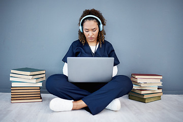 Image showing Doctor, laptop or headphones of hospital music, podcast or radio in woman study research or mock up learning by wall. Thinking, technology or medical student listening to healthcare audio for books