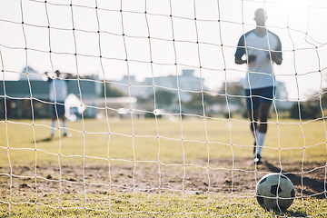 Image showing Sports, soccer and ball in net after goal, score and winning on field for training, practice and game match. Motivation, football club mockup and players outdoors for fitness, exercise and workout