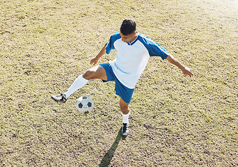 Image showing Football, soccer ball and athlete doing sports cardio, training and exercise on a grass field. Kick, game and workout outdoor with fitness and running for wellness and health for game with energy