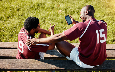 Image showing Rugby, teamwork and phone with sports man friends sitting on the bench during a game outdoor. Sport, fitness or social media with a male athlete and friend taking a break from training to rest