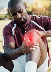 Image showing Injury, soccer player and athlete with pain on knee on a sports field, hurt and inflammation on his leg during a match. Black man, sportsman and person playing football with red overlay in fitness