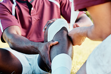 Image showing Knee pain, sport injury and bandage on athlete outdoor, rugby and fitness with black man, team and first aid. Medical emergency, wound and sports accident, training and exercise with help and medic