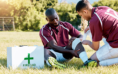 Image showing First aid, sport and black man with medic after an accident, knee pain and rugby injury. Healthcare, help and African athlete crying after a hurt muscle in sports with a doctor for medical attention