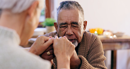 Image showing Senior couple, holding hands and praying in home for religion, hope or love for mindfulness. Elderly man, woman and support for peace, prayer and gratitude for connection to God, holy spirit or faith