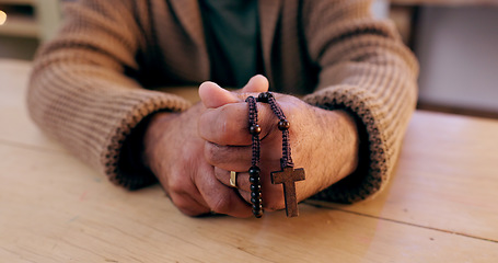 Image showing Hands, rosary and cross with closeup for religion, peace and hope at desk, home or praying for worship. Person, crucifix and jewelry for faith, mindfulness and connection to holy spirit, Jesus or God