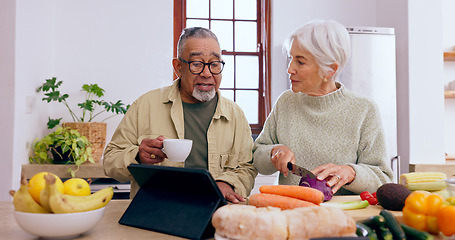 Image showing Senior couple, cooking and tablet in kitchen with knife, vegetables and tea cup for conversation. Interracial marriage, elderly woman and old man with touchscreen for app, food or nutrition in home