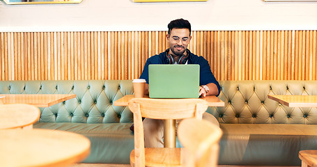 Image showing Man in cafe, typing on laptop and remote work, reading email and writing blog, article and research in restaurant. Computer, freelancer and editor in coffee shop, store and tech for internet at table