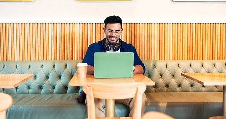 Image showing Happy man in cafe, typing on laptop and remote work, reading email or writing blog, article or search on tech. Computer, freelancer and editor in coffee shop, store or restaurant for project at table