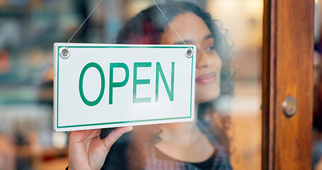 Image showing Woman, small business or open sign on window in coffee shop or restaurant for service or advertising. Ready, start or entrepreneur holding board, poster or welcome for message in retail store or cafe