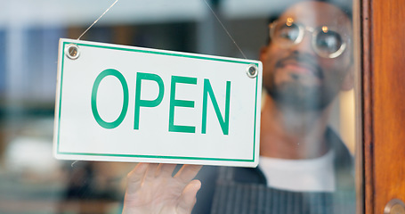 Image showing Man, small business or open sign on door in coffee shop or restaurant for service or advertising. Ready, start or entrepreneur holding board, poster or welcome for message on window in diner or cafe