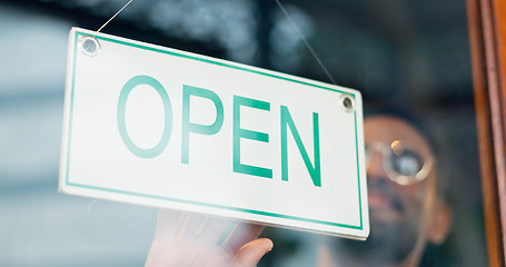 Image showing Man, business owner or open sign on door in coffee shop or restaurant for service or advertising. Ready, start or entrepreneur holding board, poster or welcome for message on window in diner or cafe