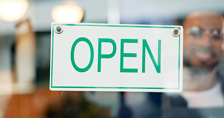 Image showing Storefront, small business or open sign on window in coffee shop or restaurant for service or advertising. Man, portrait or entrepreneur holding board, poster or welcome for message in cafe or diner