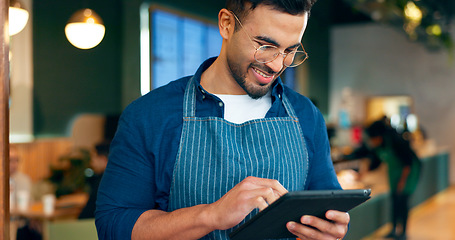 Image showing Cafe, man and business owner on tablet for restaurant sales, online management or customer service reviews. Happy entrepreneur, waiter or barista typing on digital technology for coffee shop startup