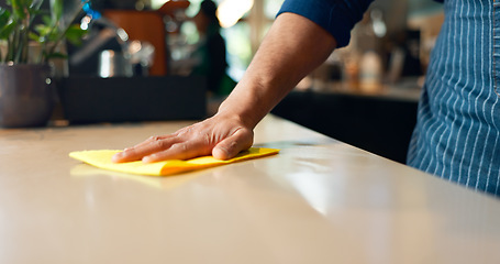 Image showing Waiter, hands and cleaning table in coffee shop for dust, bacteria and dirt with cloth, spray or detergent. Barista, person and wipe wooden furniture in cafe or restaurant for shine or professional