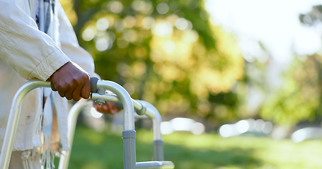 Image showing Hands, walking frame and an elderly person in a garden outdoor in summer closeup during retirement. Wellness, rehabilitation or recovery and a senior adult with a disability in the park for peace