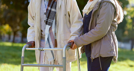 Image showing Help, person with walker and nurse in park with support, senior care or trust at nursing home. Retirement healthcare, elderly woman and caregiver walking together with nature, kindness and garden.