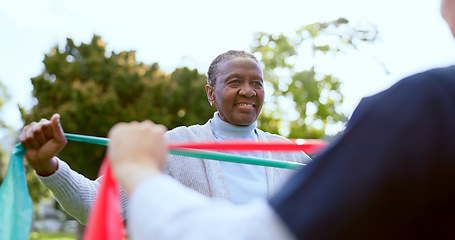 Image showing Elderly woman, stretching band and nurse outdoor for exercise, workout or fitness in a park with smile. People, professional or caregiver with physical activity for physiotherapy, wellness and health