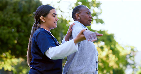 Image showing Senior, woman and nurse with arm stretching for exercise, workout or fitness in a park with smile. People, professional or caregiver with activity for physiotherapy, wellness and health in nature