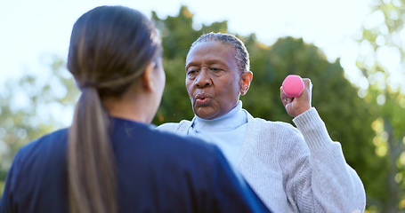 Image showing Dumbbell, fitness and a senior black woman with a volunteer outdoor in a garden together for physiotherapy. Exercise, health or wellness with an elderly patient and nurse in the yard to workout
