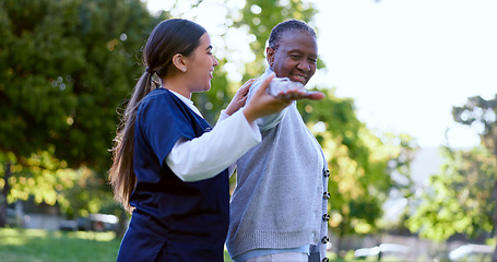 Image showing Senior, woman and caregiver with arm stretching for exercise, workout or fitness in a park with smile. People, professional or nurse with activity for physiotherapy, wellness and health in nature