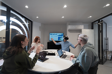 Image showing A diverse group of businessmen collaborates and tests a new virtual reality technology, wearing virtual glasses, showcasing innovation and creativity in their futuristic workspace