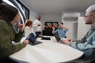 Image showing A diverse group of businessmen collaborates and tests a new virtual reality technology, wearing virtual glasses, showcasing innovation and creativity in their futuristic workspace