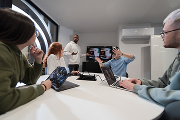 Image showing A diverse group of businessmen collaborates and tests a new virtual reality technology, wearing virtual glasses, showcasing innovation and creativity in their futuristic workspace