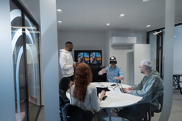 Image showing A diverse group of businessmen collaborates and tests a new virtual reality technology, wearing virtual glasses, showcasing innovation and creativity in their futuristic workspace