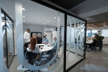 Image showing A diverse group of businessmen collaborates and tests a new virtual reality technology, wearing virtual glasses, showcasing innovation and creativity in their futuristic workspace