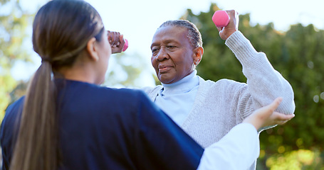 Image showing Dumbbell, fitness and a senior black woman with a nurse outdoor in a garden together for physiotherapy. Exercise, health or wellness with an elderly patient and volunteer in the yard to workout