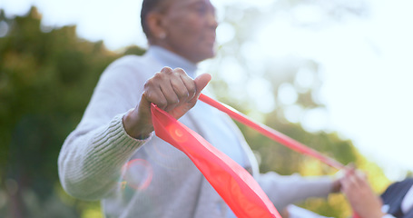 Image showing Woman, hand and resistance band for physiotherapy with exercise in garden, backyard or outdoors. Elderly person, stretching and rehabilitation for mobility with trust, support or help for wellness