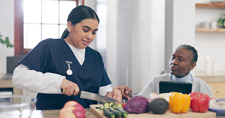 Image showing Caregiver, cooking and senior woman in home with healthy food, vegetables and nutrition in healthcare. Retirement, nurse and helping elderly person in kitchen with diet and online recipe on tablet