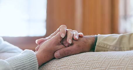 Image showing Comfort, support and senior couple holding hands in living room at modern home for romance and compassion. Love, empathy and closeup of elderly man and woman with affection in the lounge of a house.