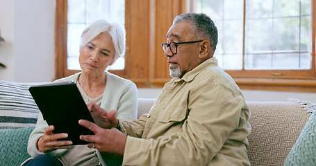 Image showing Tablet, love and an elderly couple on a sofa in the living room of their home to search social media together. Diversity, app or technology with a senior man and woman in the apartment for retirement