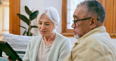 Image showing Tablet, love and a senior couple on a sofa in the living room of their home to search social media together. Interracial, app or tech with an elderly man and woman in the apartment for retirement