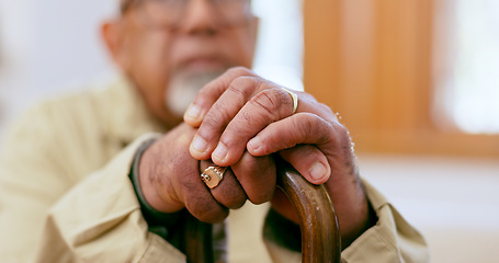 Image showing Hands, walking stick and a senior person with a disability in the living room of a home closeup for retirement. Balance, retirement and wellness with an elderly adult holding a cane for support