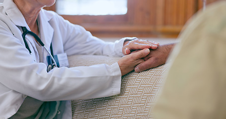 Image showing Support, care and doctor holding hands with patient for medical diagnosis or treatment planning. Consulting, career and closeup of healthcare worker comforting a man in living room of nursing home.