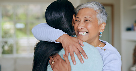 Image showing Hug, happy and mother and daughter in home for bonding, relationship and smile together for love. Family, visit and mature mom embrace adult woman for mothers day, support and care in living room