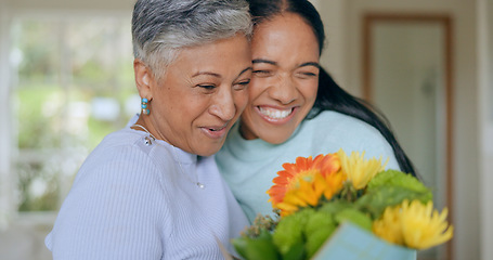 Image showing Hug, love and mother and daughter with flowers in home for bonding, relationship and smile together. Family, happy and mature mom embrace adult woman for mothers day, support and care in living room