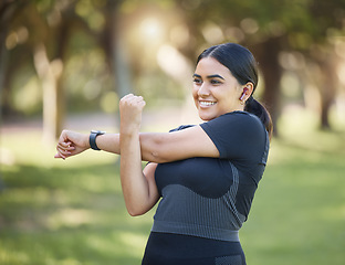 Image showing Fitness, nature and happy woman stretching in an outdoor park for health, wellness and training. Sports, healthy and girl athlete from Mexico doing a warm up exercise before a workout in green garden