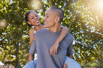 Image showing Love, tree leaf and couple hug while bonding, having fun and enjoy romantic quality time together in nature park date. Peace freedom, piggyback ride and happy black woman and gen z man play outdoor