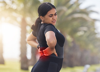 Image showing Red, back pain and woman fitness in park or city for exercise, running or workout healthcare with burnout, stress and body risk of arthritis. Tired, injury and sports person or runner with spine pain