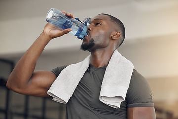 Image showing Fitness, gym and black man drinking water after workout or training for hydration, health or wellness. Strong, healthy and African athlete enjoying a beverage after intense exercise at sports center.