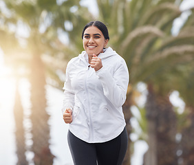 Image showing Running, happy and woman outdoor training for a runner marathon, exercise and fitness. Sport wellness, run workout and healthy sports cardio of plus size athlete happiness from India in the morning