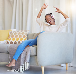 Image showing Black woman, headphones and happy on couch, for dancing and listening to music in living room with smile. Headset, African American girl and female streaming audio, radio and on sofa for happiness.