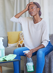 Image showing House cleaning, black woman and tired person in a living room with stress and anxiety from home work. Dust, cleaner and maid service of a young female with dust spray and housekeeping wash product