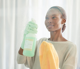 Image showing Cleaning, black woman and spray product of a cleaner washing a mirror with a smile. Working maid doing home hygiene with a bottle and cloth to disinfect the house furniture, glass and window