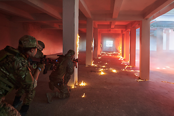 Image showing A professional cameraman captures the intense moments as a group of skilled soldiers embarks on a dangerous mission inside an abandoned building, their actions filled with suspense and bravery